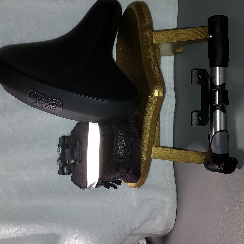 A bike seat bike pump under bike seat storage bag